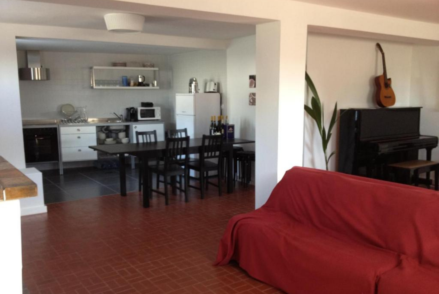 Open living room and kitchen with music corner in the AirPorto Hostel